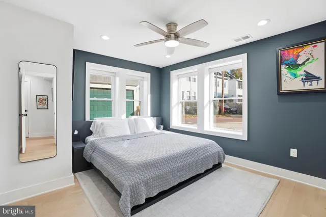 a bedroom with a bed and a large window