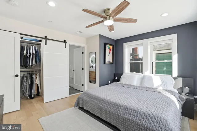 a bedroom with a large bed closet and a window