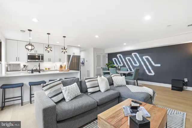 a living room with furniture and kitchen view