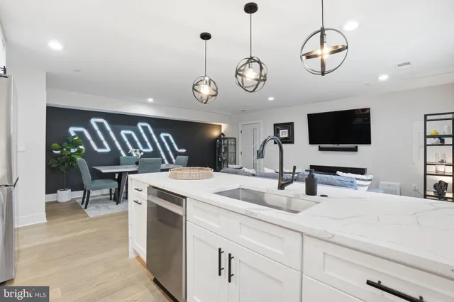 a kitchen with cabinets and outdoor living space
