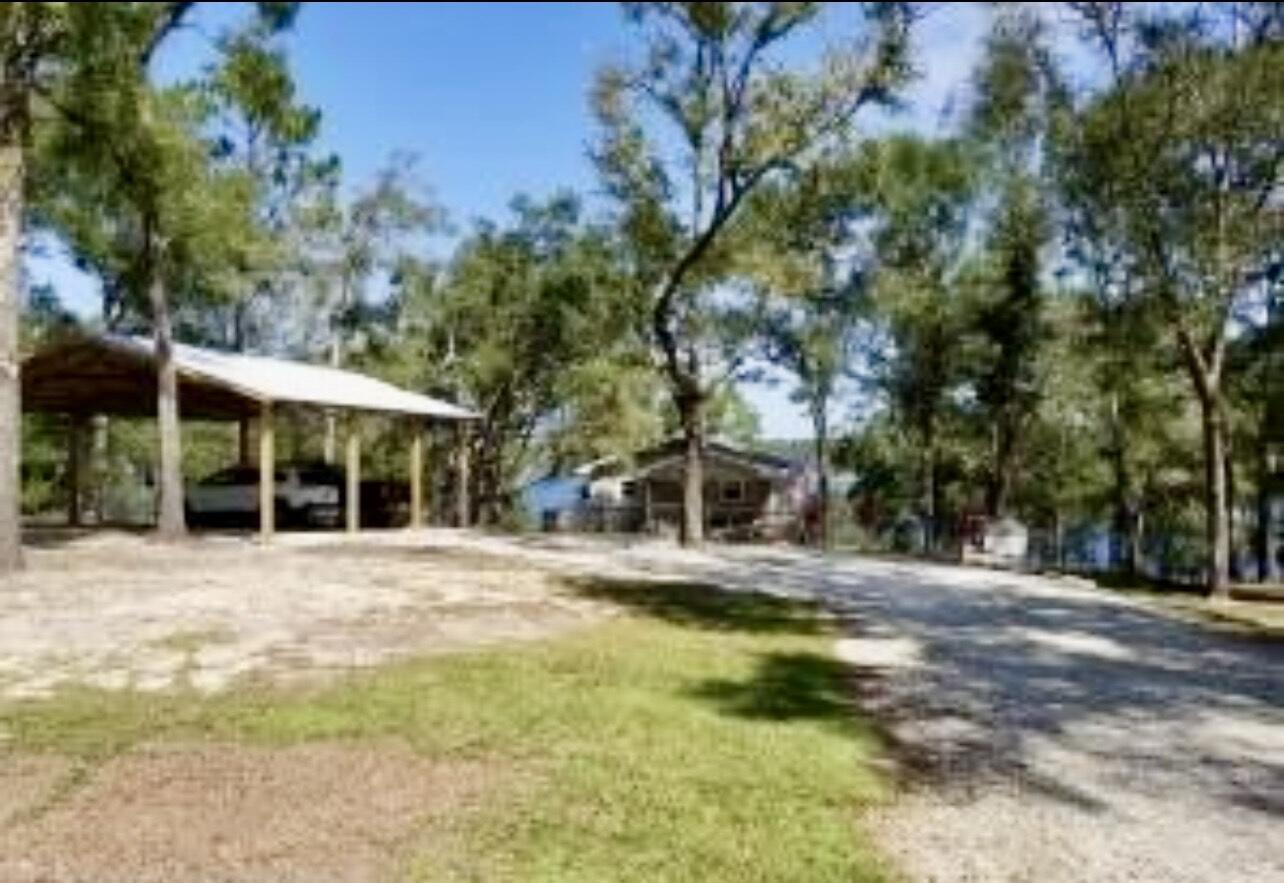 3511 Quail Ridge Drive Chipley, FL 32428 - Photo 3 of 11 a view of a house with a yard and tree s