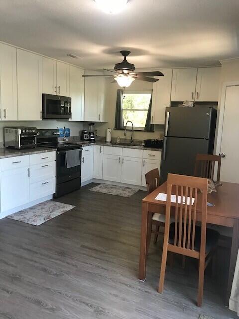 3511 Quail Ridge Drive Chipley, FL 32428 - Photo 5 of 11 a kitchen with granite countertop a stove refrigerator dining table and chairs