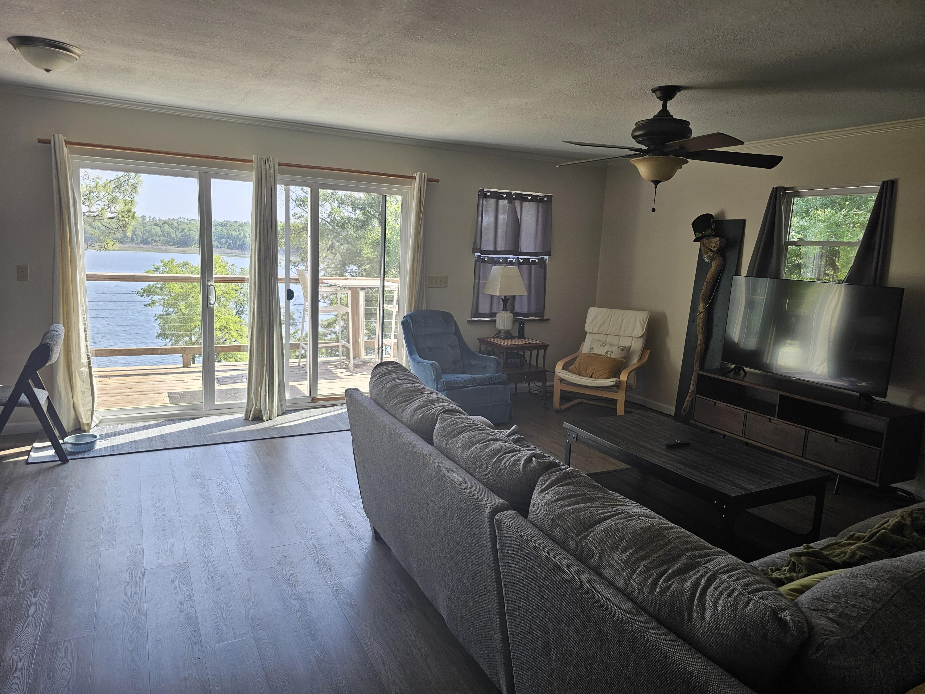 3511 Quail Ridge Drive Chipley, FL 32428 - Photo 9 of 11 a living room with furniture and a flat screen tv