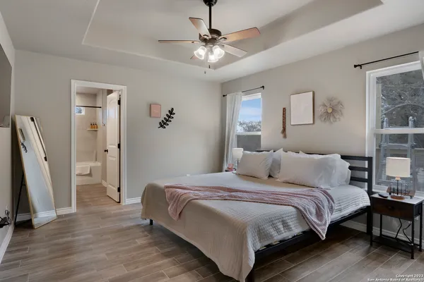 a bedroom with a bed and a chandelier