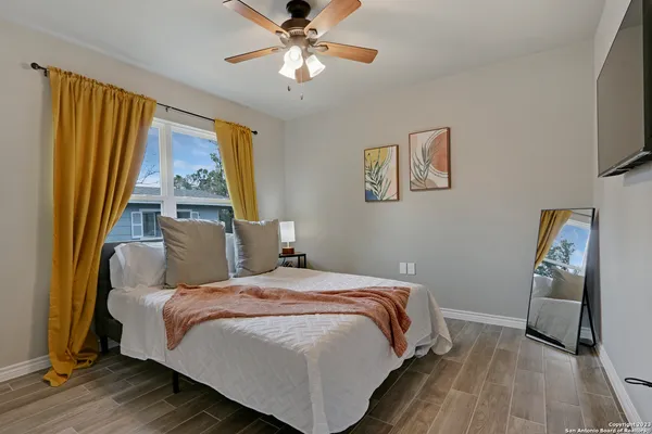 a bedroom with a bed and a flat screen tv