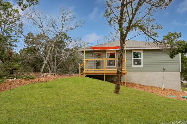 a view of house with yard and sitting area