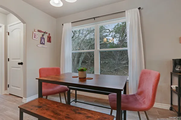 a view of a dining room with furniture window and wooden floor