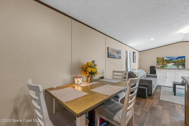 a view of a dining hall with furniture and wooden floor