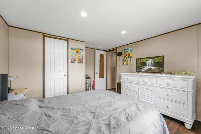 a bedroom with a large bed and closet