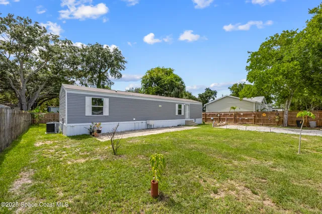 a house view with a sitting space and garden