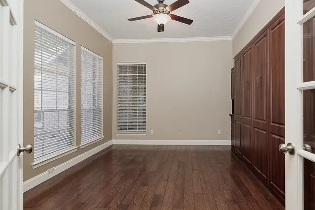 a view of wooden floor and windows in a room