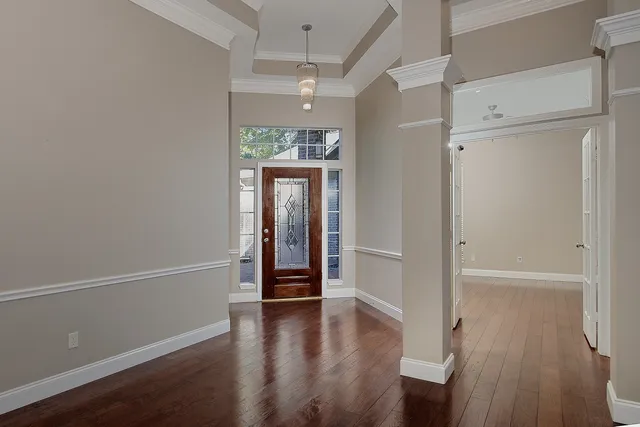 a view of a room with wooden floor and windows