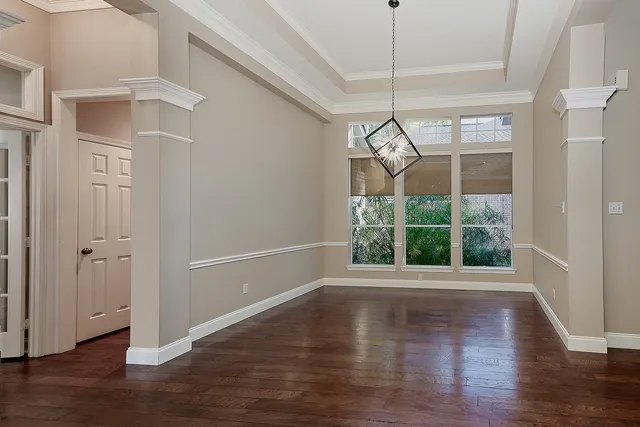 a view of a living room with wooden floor and a fireplace