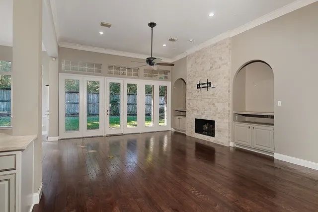 a view of an empty room with a fireplace and a window