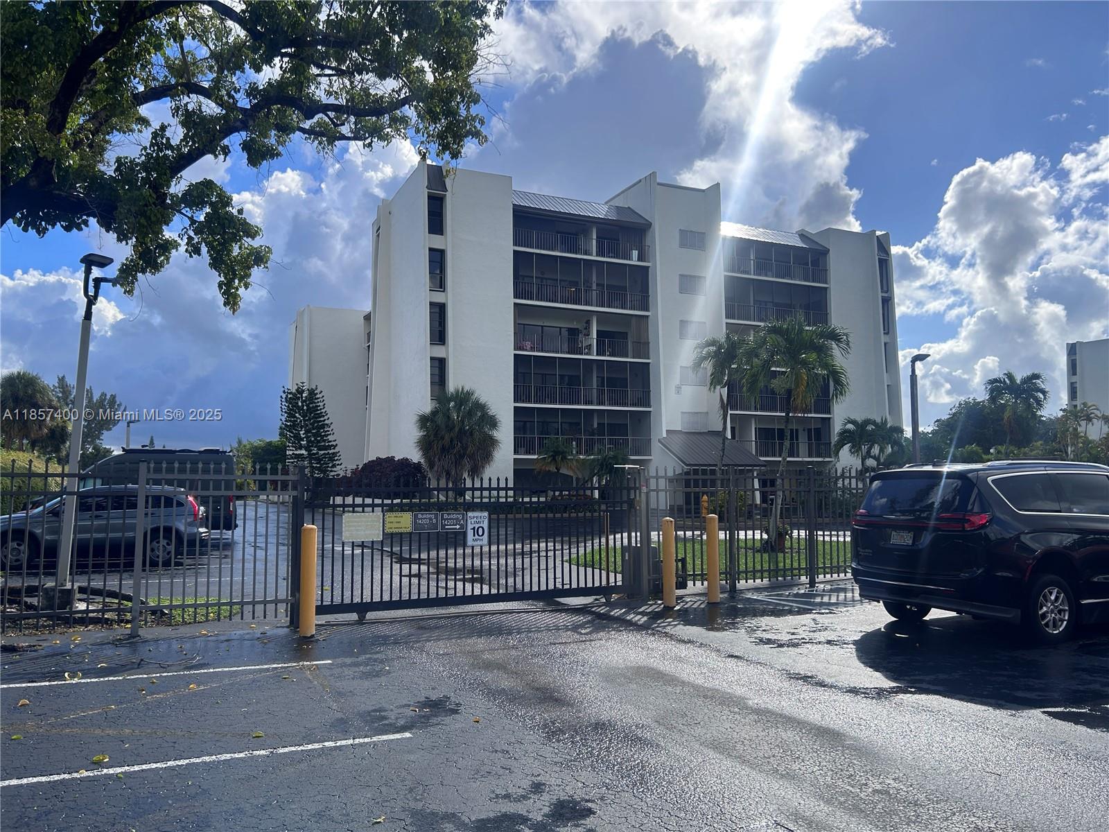 14201 Southwest 66th Street, Unit 306 Miami, FL 33183 - Photo 1 of 38 a view of a chair and table in the back yard of the house