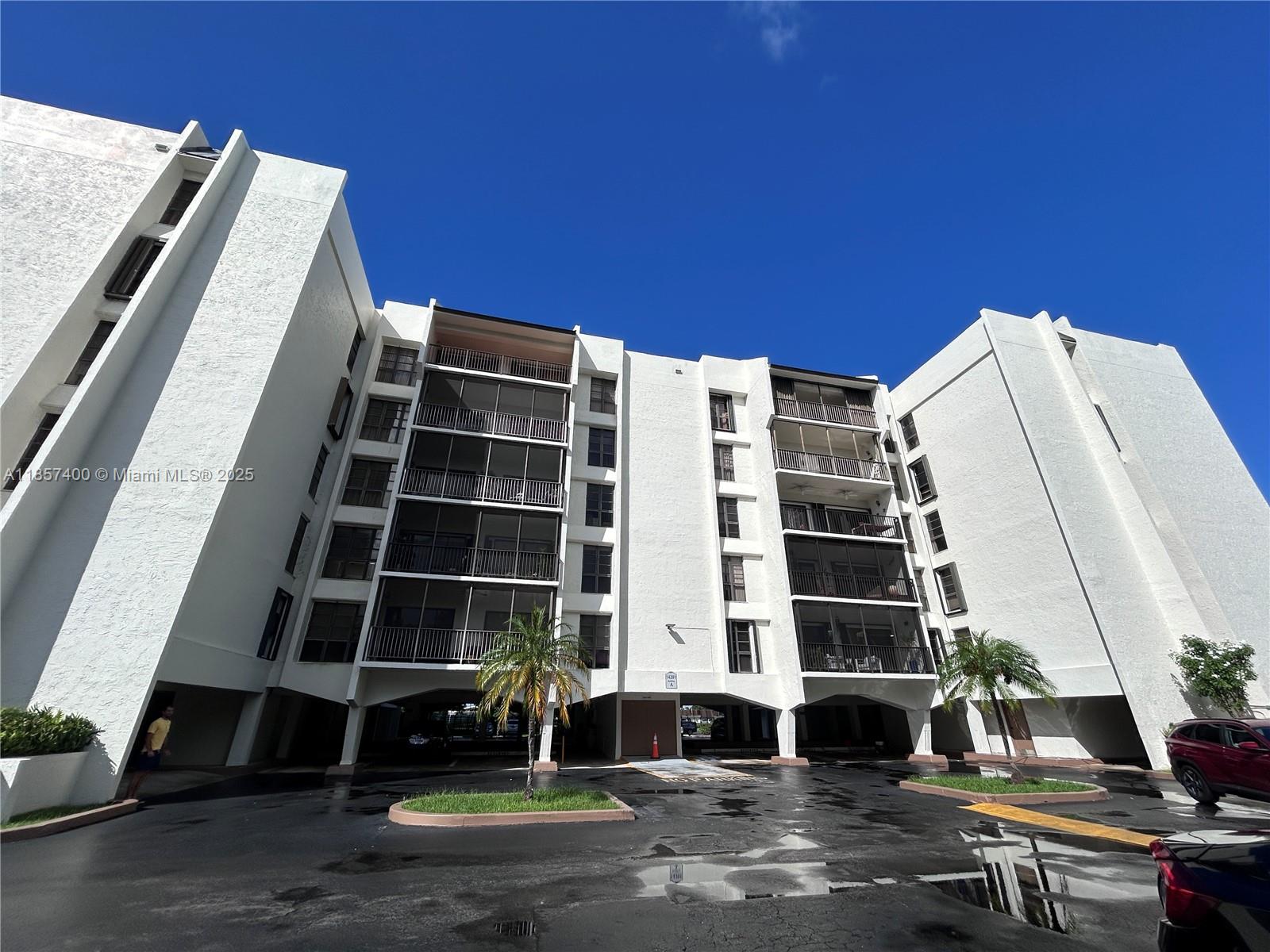 14201 Southwest 66th Street, Unit 306 Miami, FL 33183 - Photo 33 of 38 a view of house with a large window and wooden fence