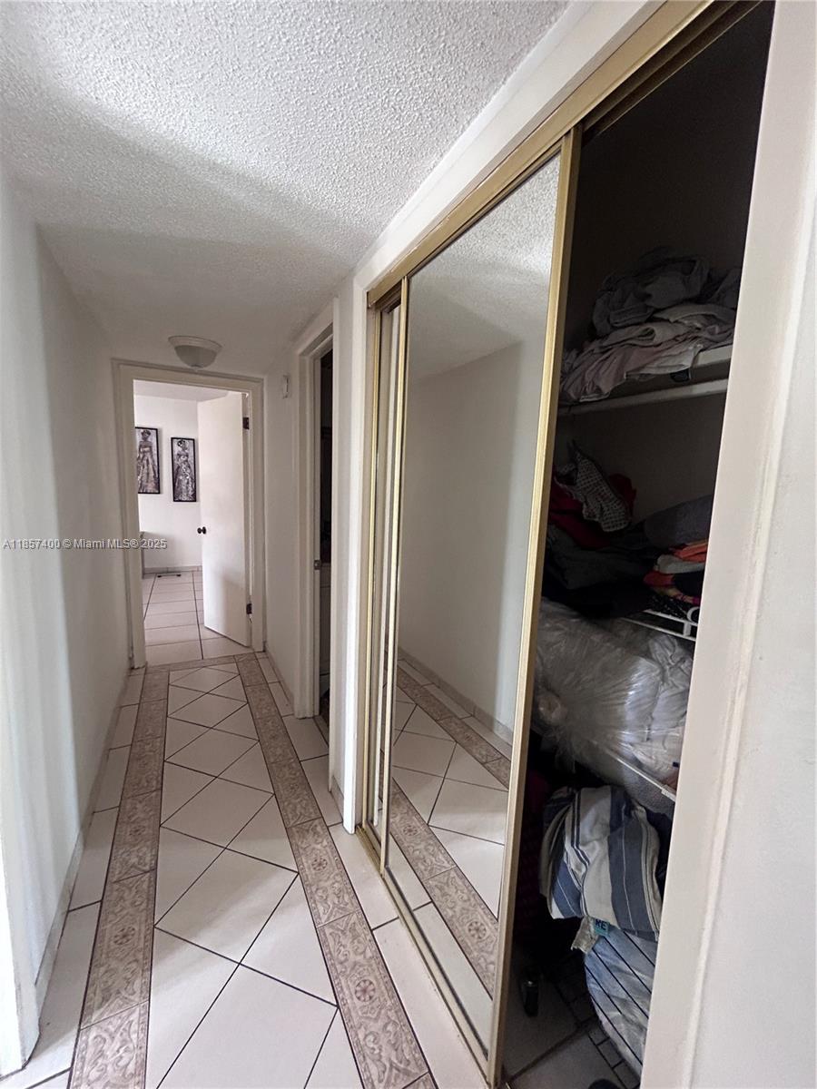 14201 Southwest 66th Street, Unit 306 Miami, FL 33183 - Photo 10 of 38 a view of a closet area with living room