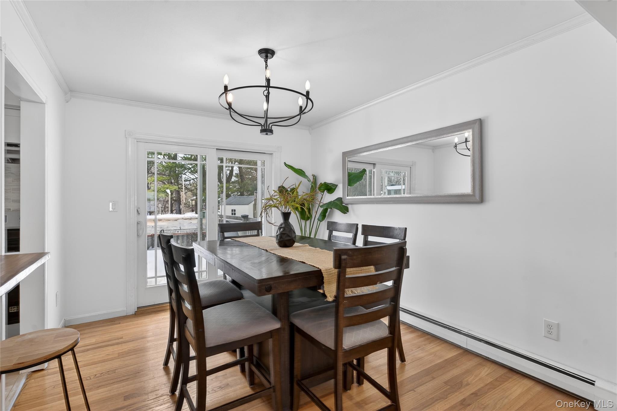 100 Watch Hill Drive Fishkill, NY 12524 - Photo 11 of 49 Dining area with a baseboard radiator, ornamental molding, light wood finished floors, and hanging lights