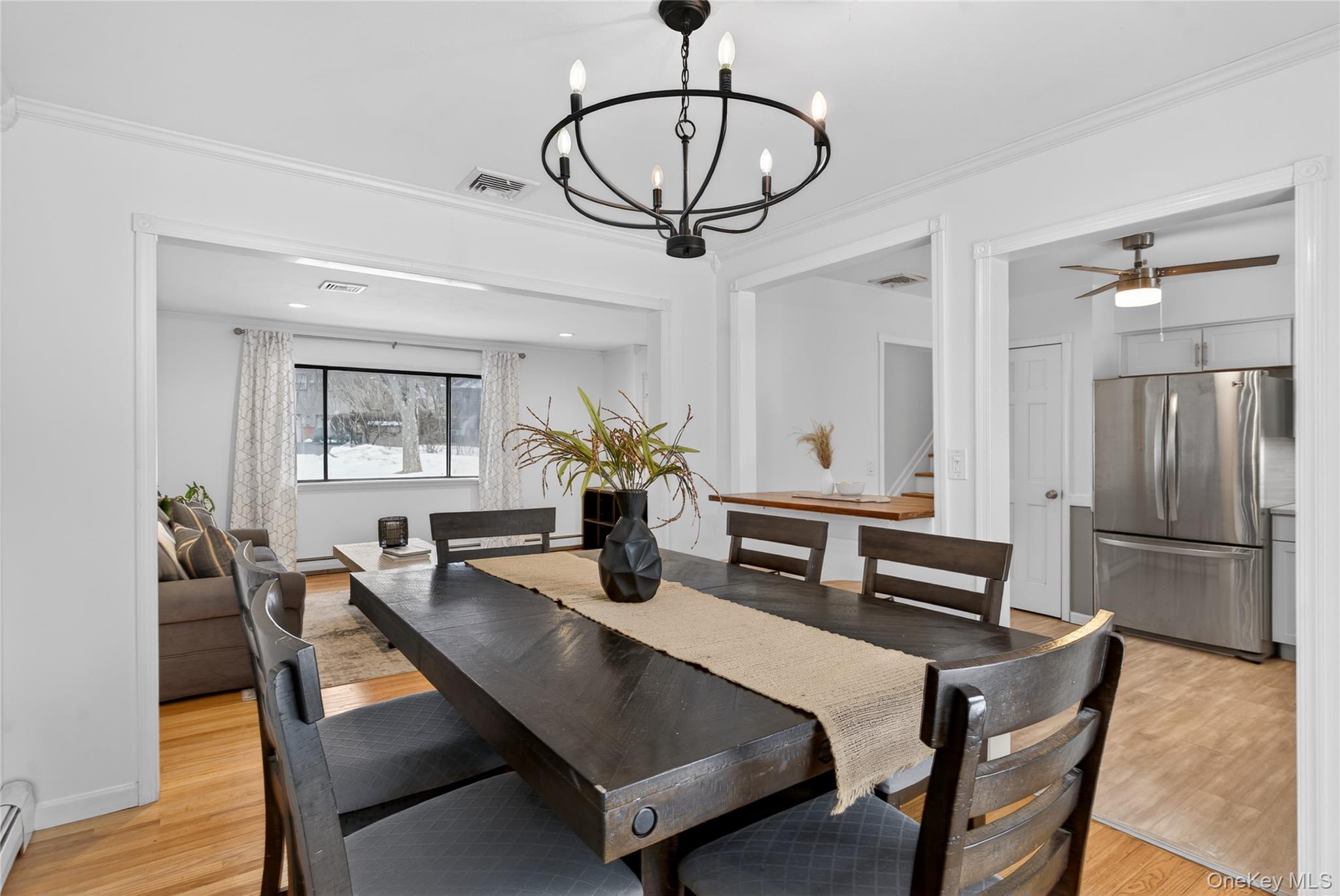 100 Watch Hill Drive Fishkill, NY 12524 - Photo 13 of 49 Dining space with light wood-style floors, hanging lights, crown molding, ceiling fan, and a baseboard radiator