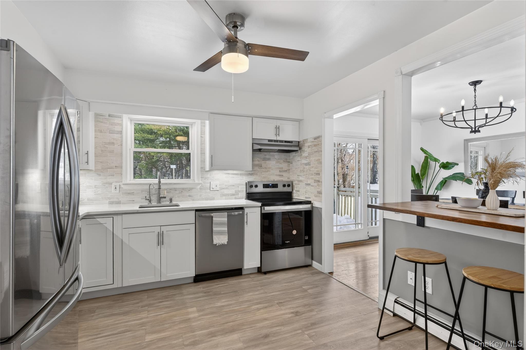 100 Watch Hill Drive Fishkill, NY 12524 - Photo 14 of 49 Kitchen featuring stainless steel appliances, wooden counters, a baseboard radiator, light wood-style flooring, and a chandelier