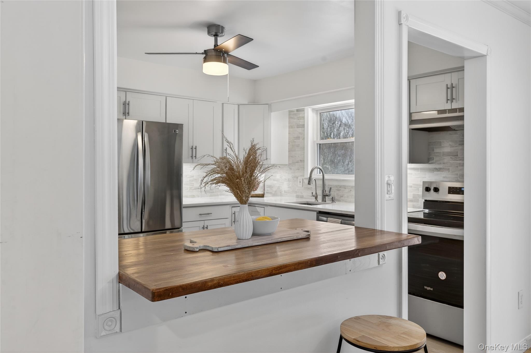 100 Watch Hill Drive Fishkill, NY 12524 - Photo 18 of 49 Kitchen featuring wooden counters, stainless steel appliances, decorative backsplash, and ceiling fan
