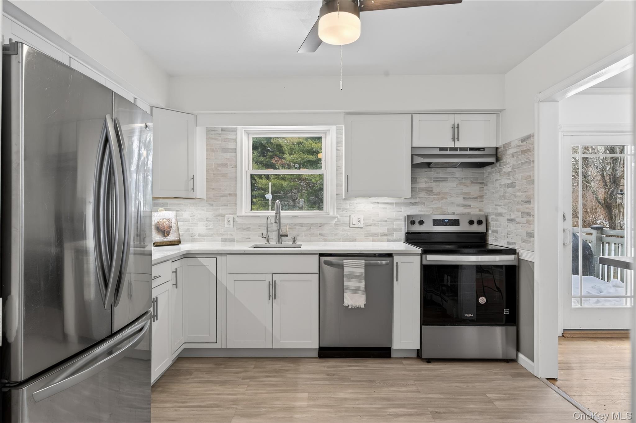 100 Watch Hill Drive Fishkill, NY 12524 - Photo 20 of 49 Kitchen with stainless steel appliances, white cabinets, light wood-type flooring, and ceiling fan