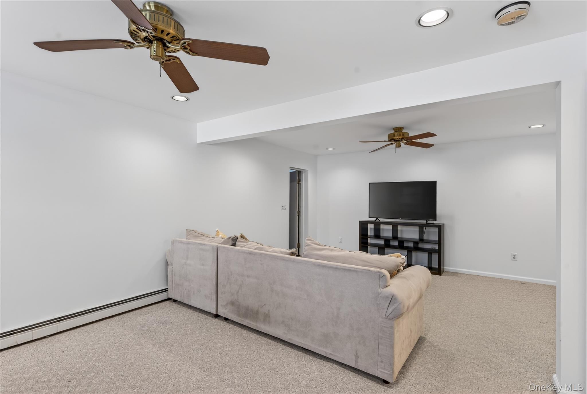 100 Watch Hill Drive Fishkill, NY 12524 - Photo 28 of 49 Living room featuring a ceiling fan, light colored carpet, baseboard heating, and recessed lighting