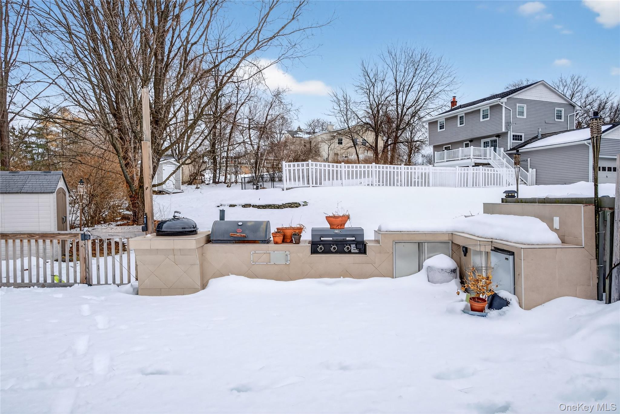 100 Watch Hill Drive Fishkill, NY 12524 - Photo 38 of 49 Yard layered in snow featuring a storage unit, area for grilling, and a residential view