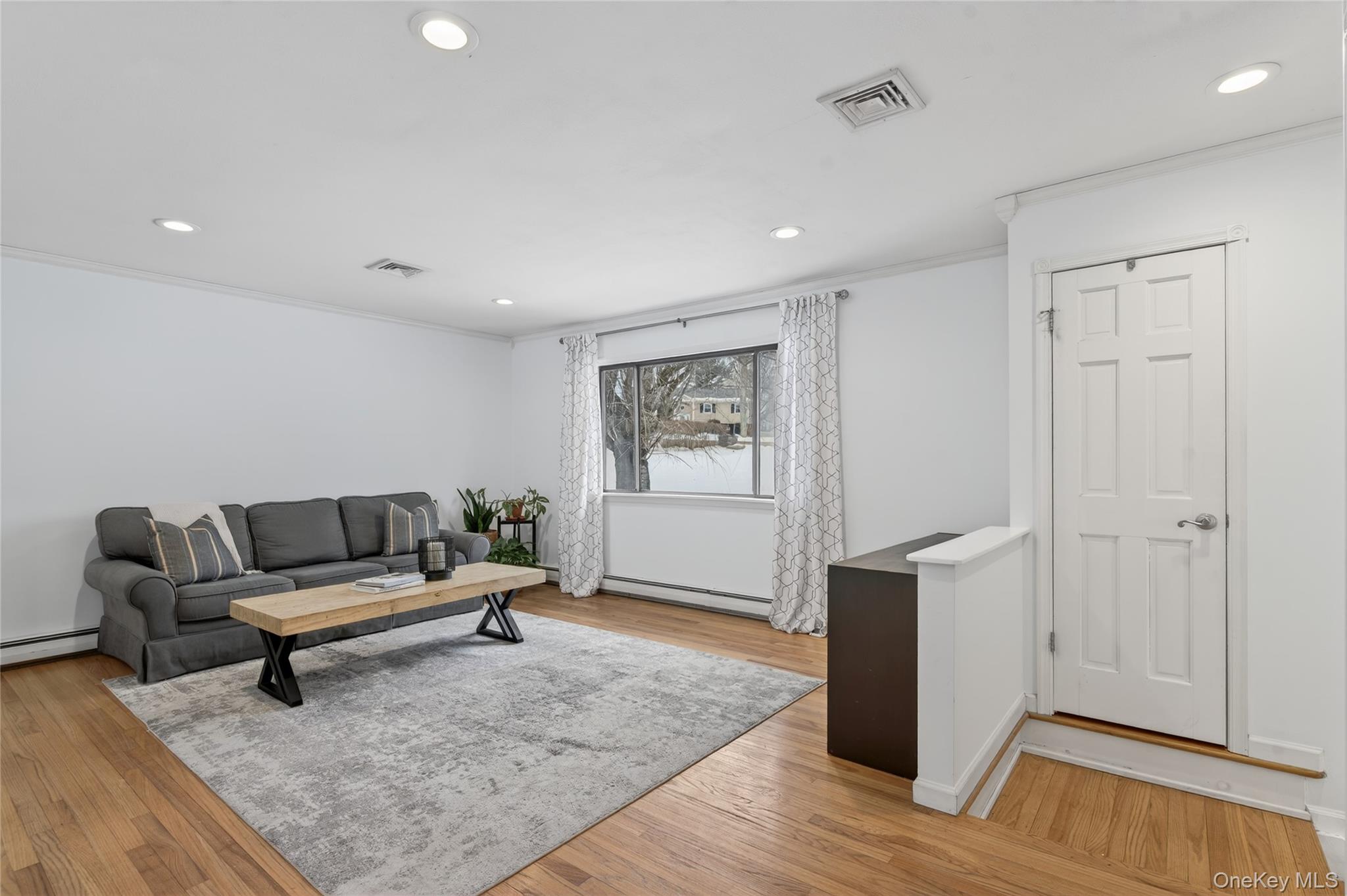 100 Watch Hill Drive Fishkill, NY 12524 - Photo 8 of 49 Living area featuring light wood-style floors, ornamental molding, recessed lighting, and baseboard heating