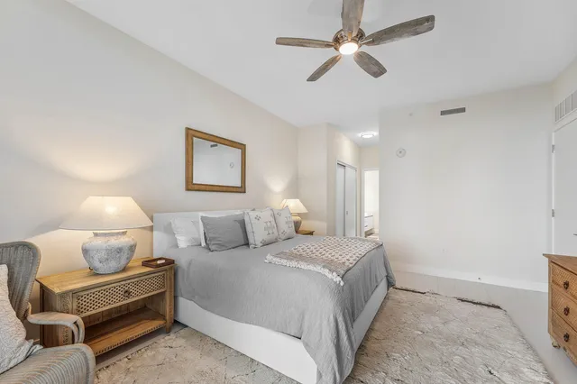 a bedroom with a bed and ceiling fan