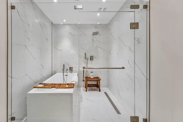 a bathroom with a tub sink and mirror