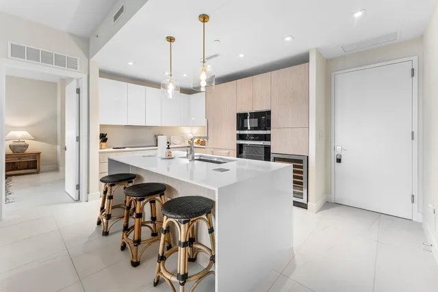 a kitchen with kitchen island a counter top space appliances and cabinets