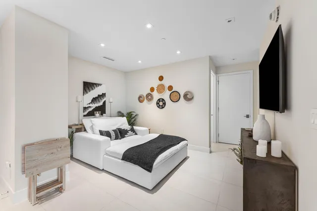 a bedroom with furniture and a flat screen tv