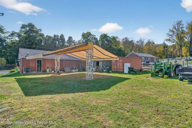 a view of a house with a yard patio and a slide