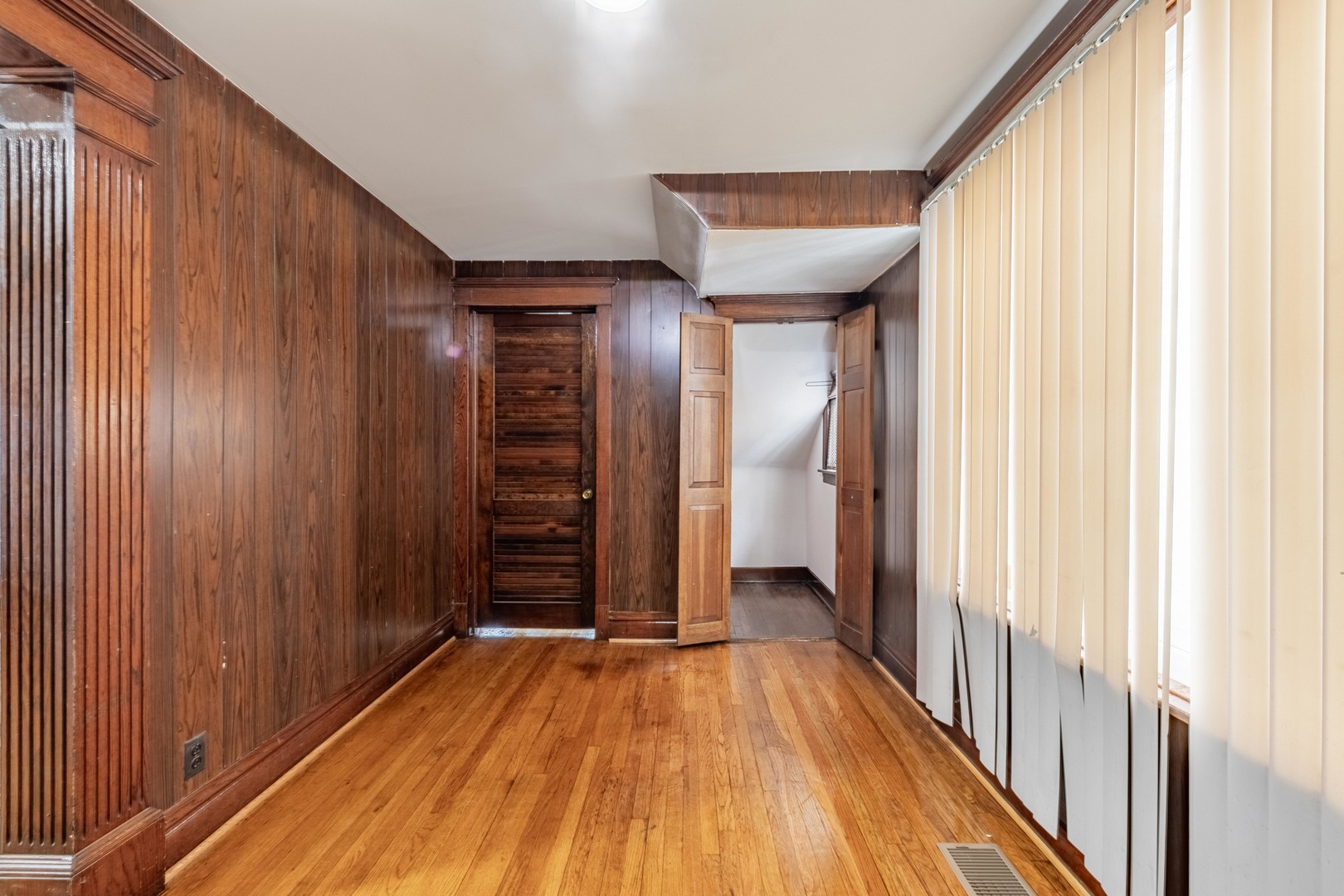 7629 South Green Street Chicago, IL 60620 - Photo 13 of 53 a view of a hallway with wooden floor and staircase