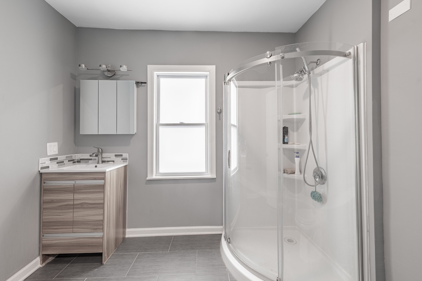 7629 South Green Street Chicago, IL 60620 - Photo 26 of 53 a bathroom with a shower sink and mirror