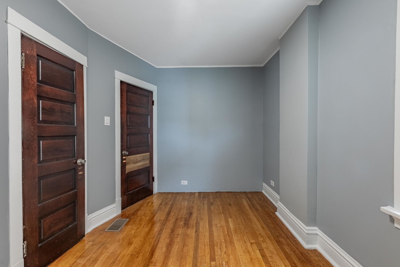 7629 South Green Street Chicago, IL 60620 - Photo 31 of 53 a view of a room that has wooden floor and closet