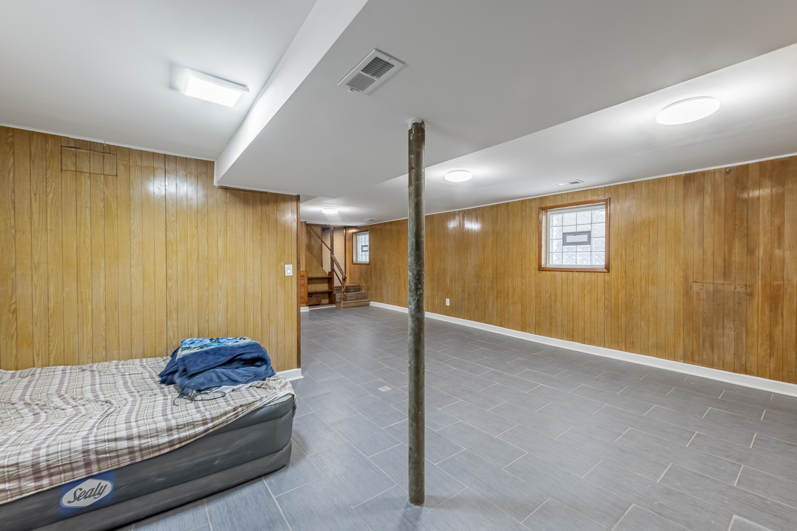 7629 South Green Street Chicago, IL 60620 - Photo 39 of 53 a living room with furniture and a chandelier