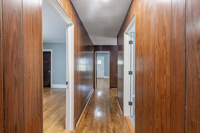 a view of hallway with wooden floor
