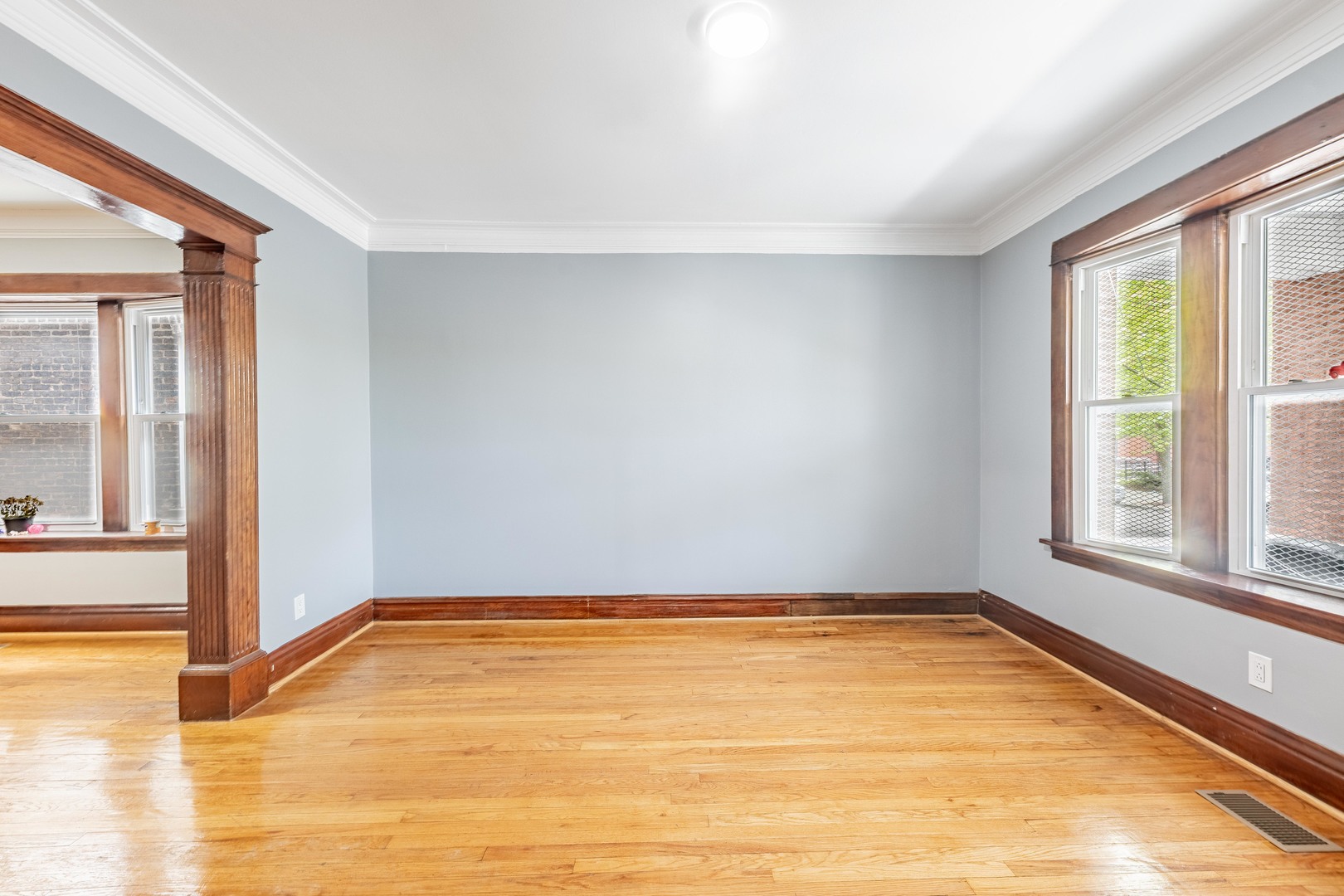 7629 South Green Street Chicago, IL 60620 - Photo 6 of 53 a view of a room with wooden floor and a window