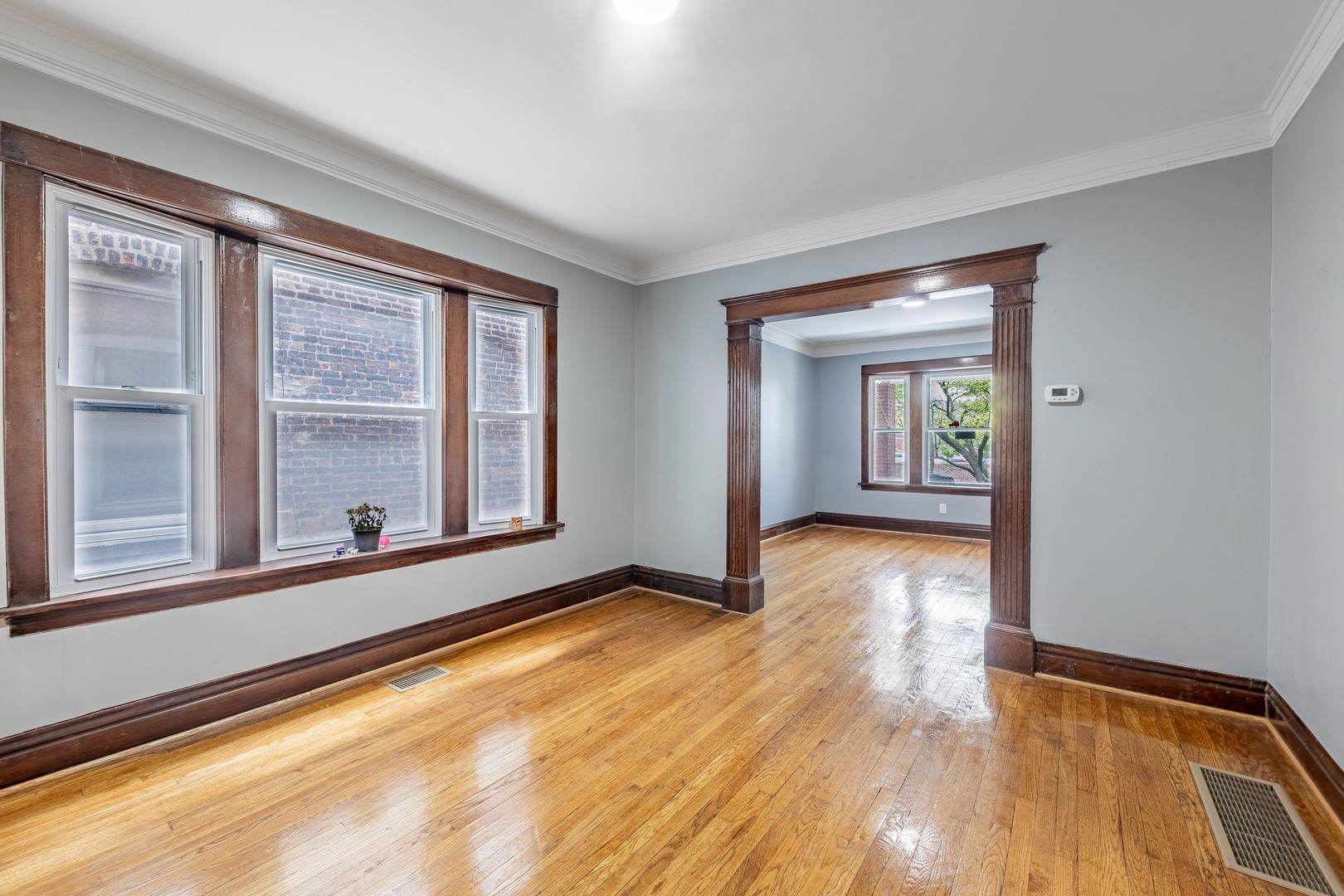 7629 South Green Street Chicago, IL 60620 - Photo 9 of 53 wooden floor in an empty room with a window