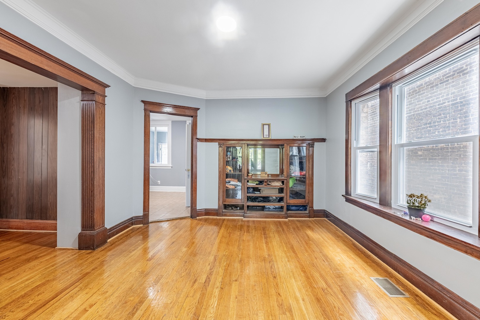 7629 South Green Street Chicago, IL 60620 - Photo 10 of 53 a view of a living room with furniture wooden floor and a large window