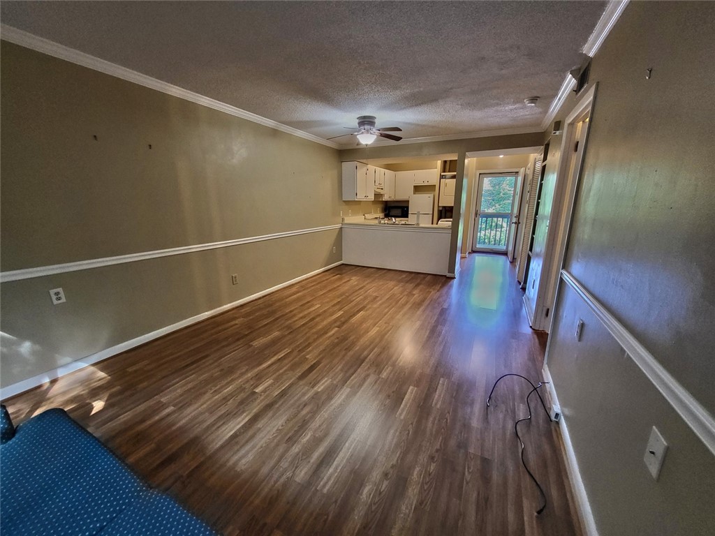 150 Ligon Street, Unit 1001 Clemson, SC 29631 - Photo 12 of 29 An open-concept layout presents rich wood flooring extending from the living area to a compact kitchen.