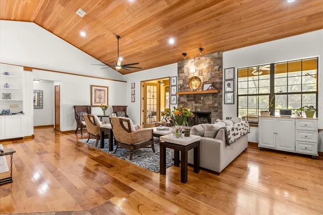 a kitchen with stainless steel appliances granite countertop a table chairs sink and cabinets