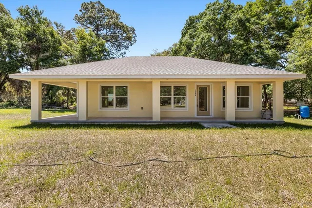 a front view of a house with a yard table and chairs