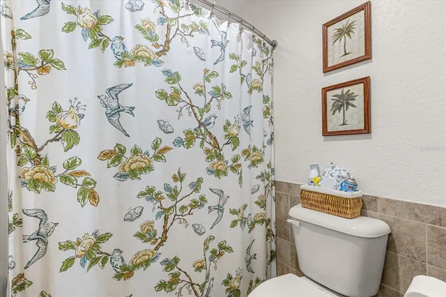 a bathroom with a sink mirror and toilet
