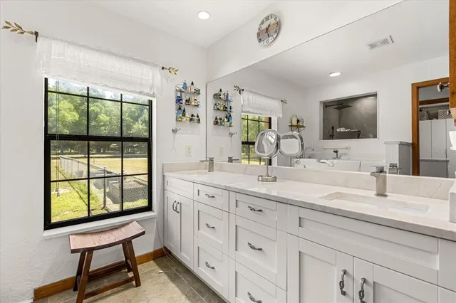 an empty room with windows and a ceiling fan