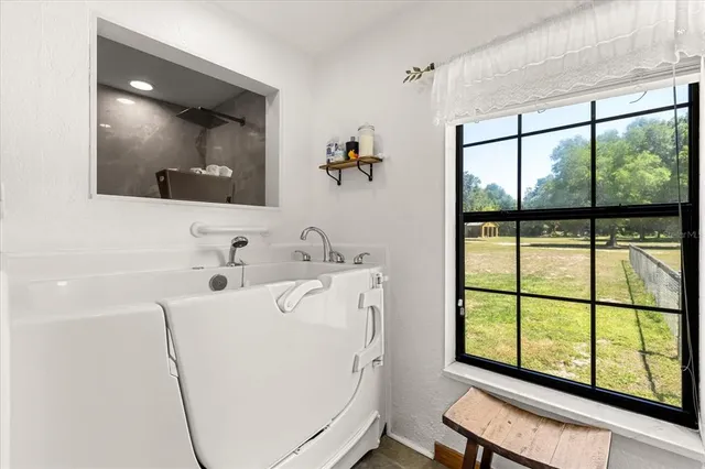 a kitchen with kitchen island granite countertop a stove a sink a refrigerator a center island and cabinets