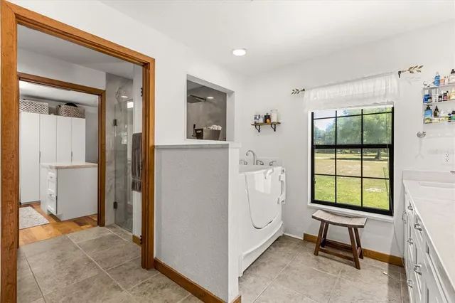 a kitchen with kitchen island a counter top space cabinets and stainless steel appliances
