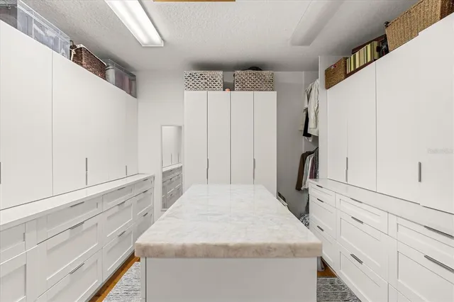 a bathroom with a granite countertop sink a toilet and bathtub